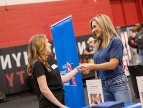 A student shakes hands with a representative from First Citizens at Success Fest 2023